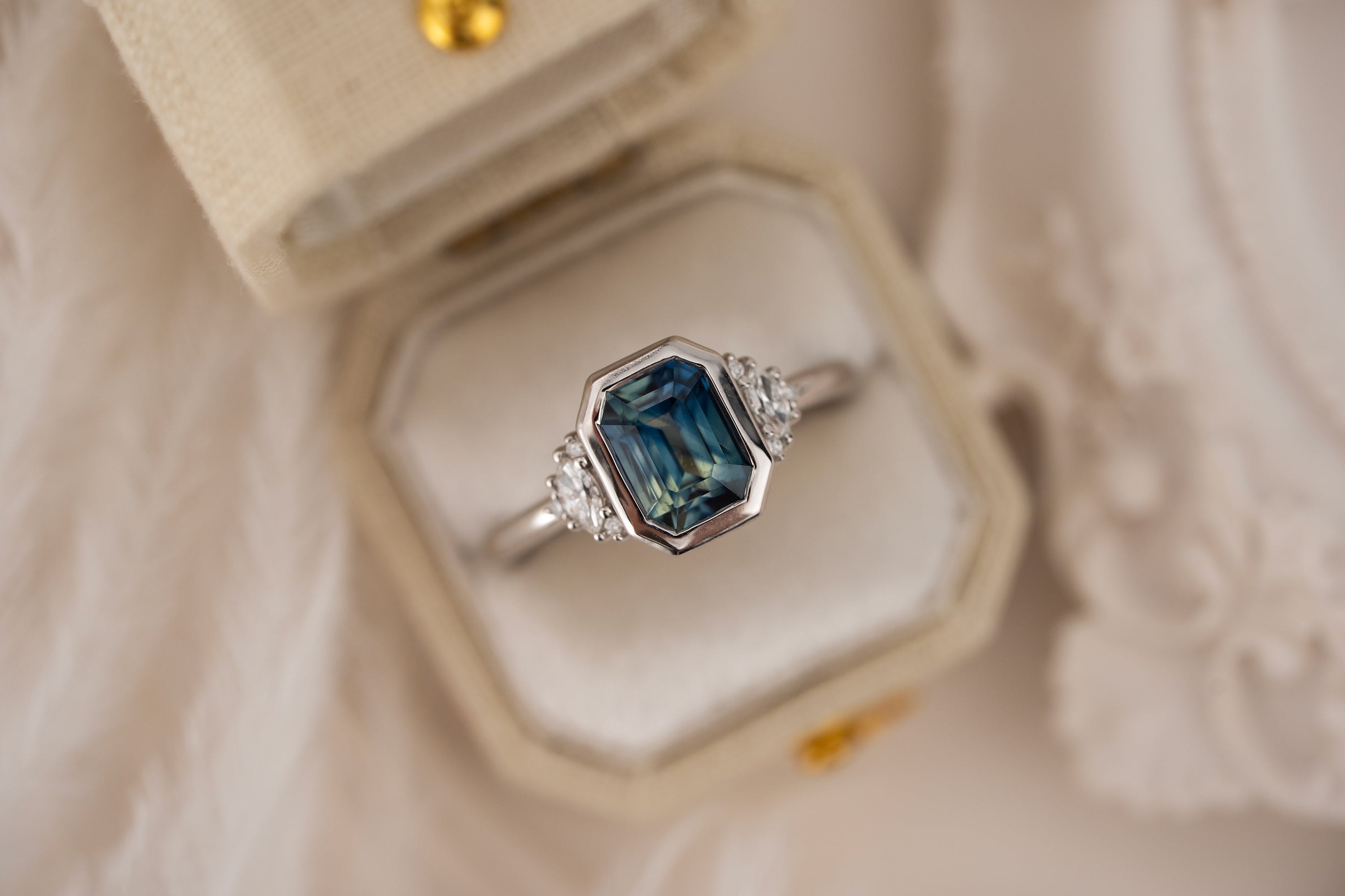 The Low Bezel Maren Ring | 2.22 CT Emerald Cut Bicolor Blue Sapphire