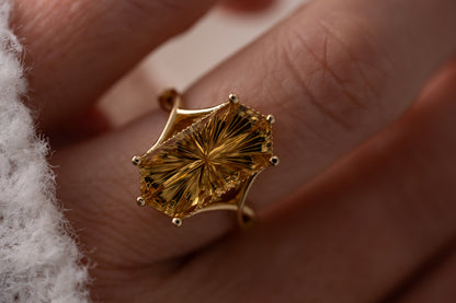 Gold ring with a textured design on a finger