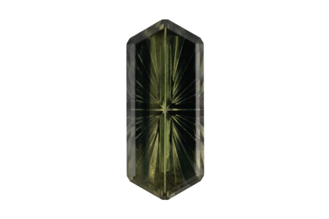 Faceted green gemstone on a white background